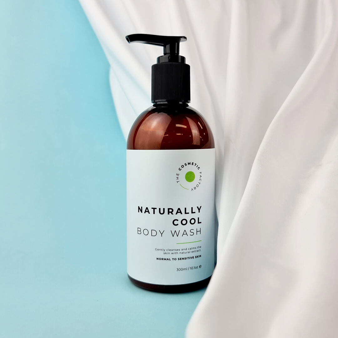 a bottle of naturally cool body wash 300ml in front of a soft curtain.