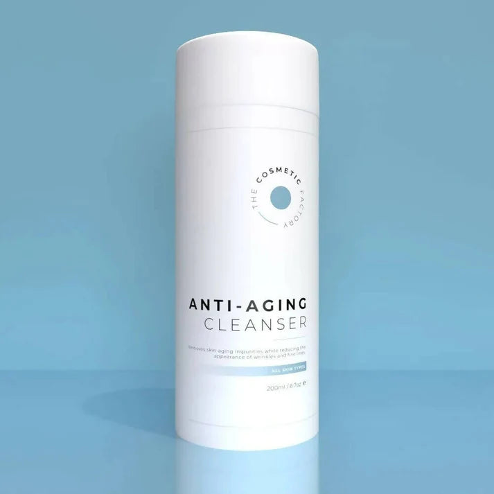 a bottle of anti-aging cleanser 200ml on a blue surface.