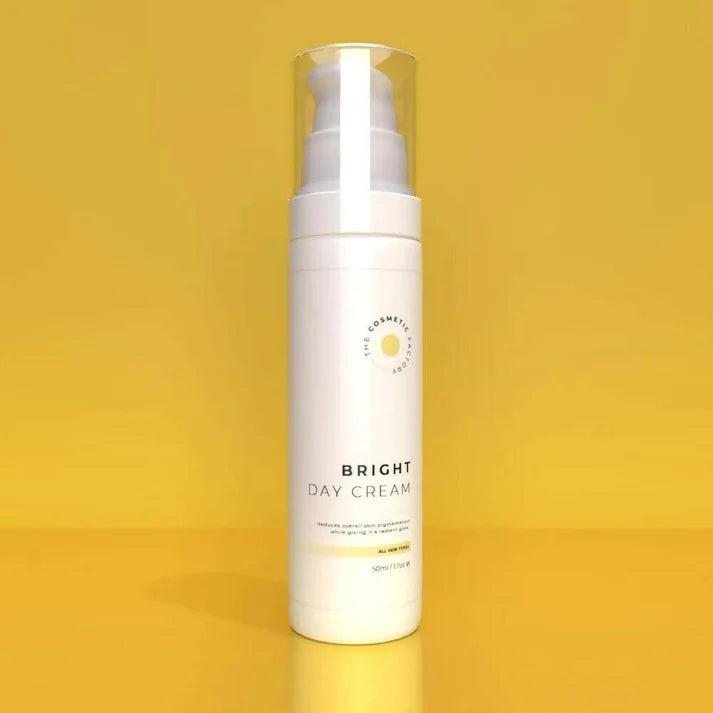 a bottle of bright day cream 50ml on a yellow surface.
