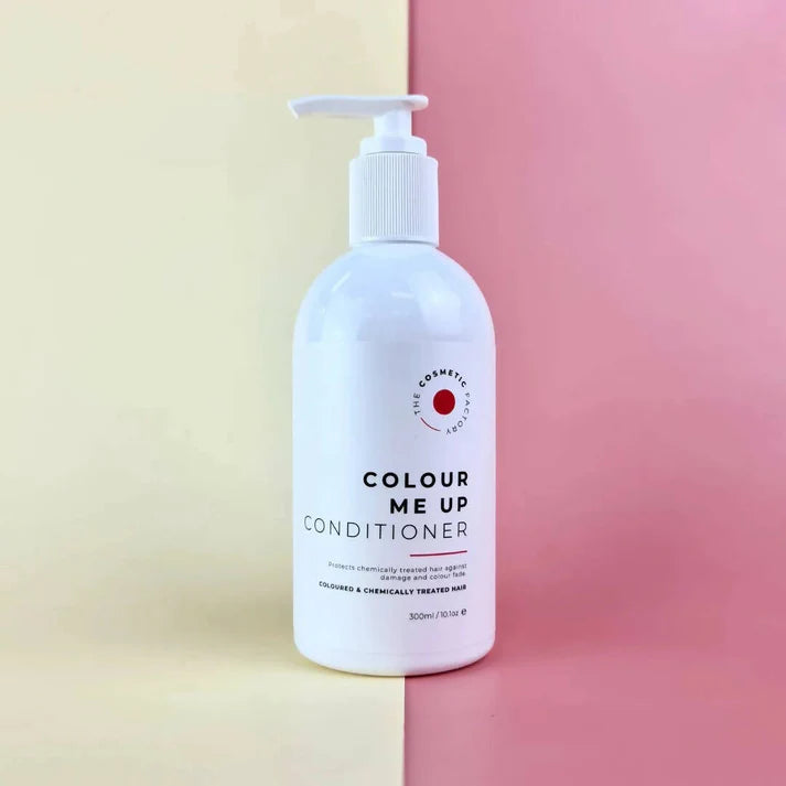 a bottle of colour me up shampoo 300ml on a red surface.