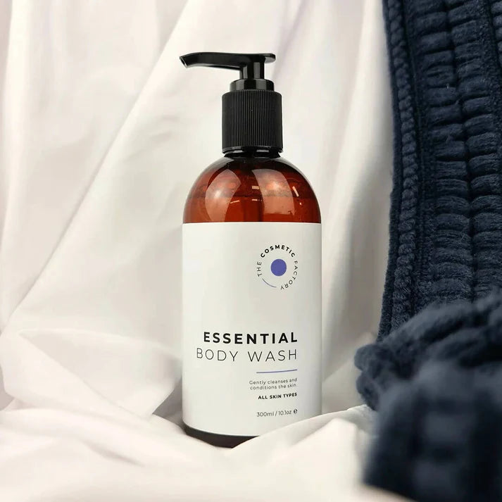 a essential body wash 300ml on a soft surface.