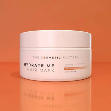 a jar of hydrate me hair mask 250ml on an orange background.