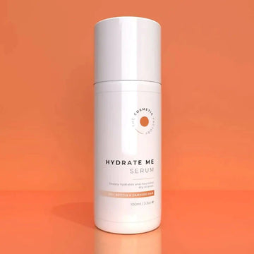 a bottle of hydrate me serum 100ml on an orange background.