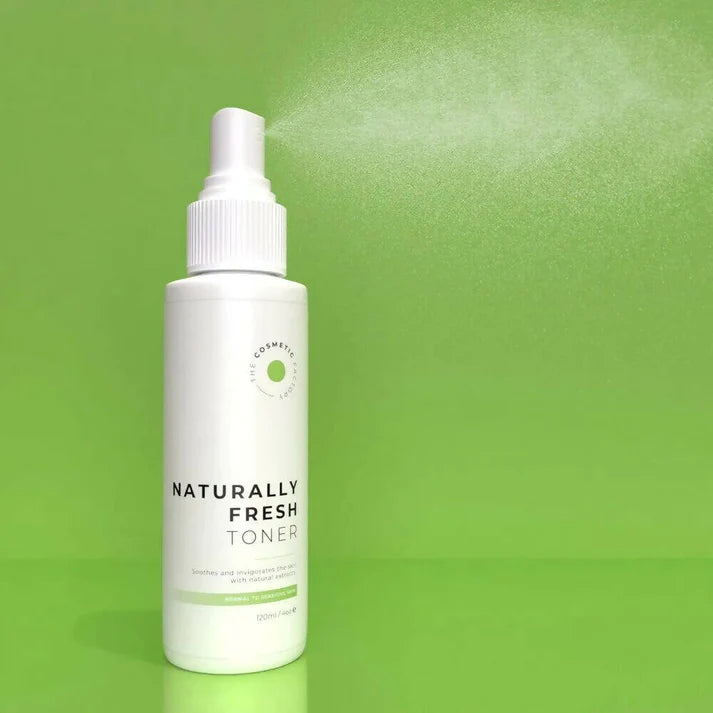 a bottle ofnaturally fresh toner 125ml on a green backgroundwith mist.