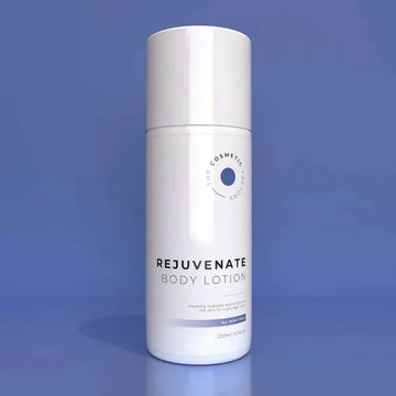 a bottle of rejuvenate body lotion 200ml on a blue surface.