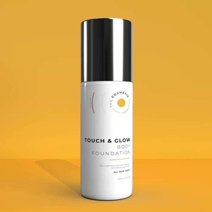 a bottle of touch & glow body foundation 200ml on a yellow background.