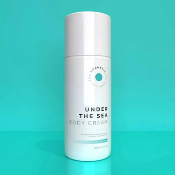 a bottle of under the sea body cream 200ml on a blue background.